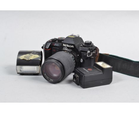 A Nikon N2000 SLR Camera, serial no 3350681, body G, battery compartment corroded, untested, with a RMC Tokina 35-105mm f/3.5