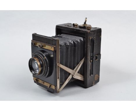 A Contessa Nettel Folding Strut Camera,  9 x 12cm format, shutter loads and fires, creasing to curtian, body G, some apparent