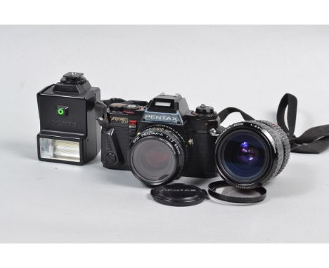 A Pentax Program A SLR Camera, serial no 1318624, black, body F, whitening to front of pentaprism housing, shutter working on