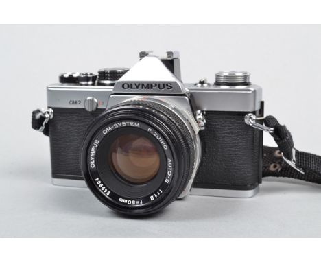 An Olympus OM 2 SLR Camera, serial no 508614, shutter working, meter responsive, timer working, body G, light scratches to ba