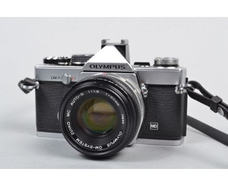 An Olympus OM 2 MD SLR Camera, serial no 1117500, shutter working, meter responsive, timer working, body G, light scratches t