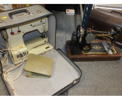 A VINTAGE BERNINA SEWING MACHINE TOGETHER WITH A CASED SINGER SEWING MACHINE (2) 