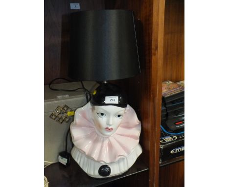 A CERAMIC TABLE LAMP IN THE FORM OF A JESTER