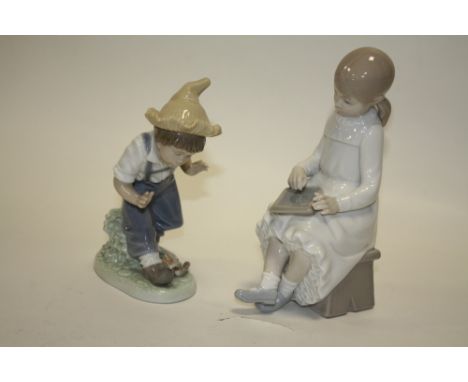 TWO NAO FIGURES OF A BOY WITH BIRDS AND A GIRL WITH A DRAWING BOARD
