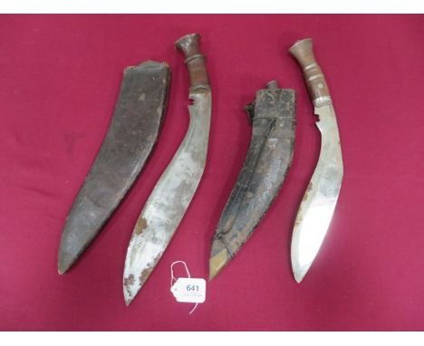 Two Indian Kukri  single edged military pattern blade of typical form. Wooden grip. Contained in its leather covered wooden s