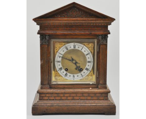 German oak cased bracket clock, with a brass dial, Roman numerals, striking on a gong, height 41cm.