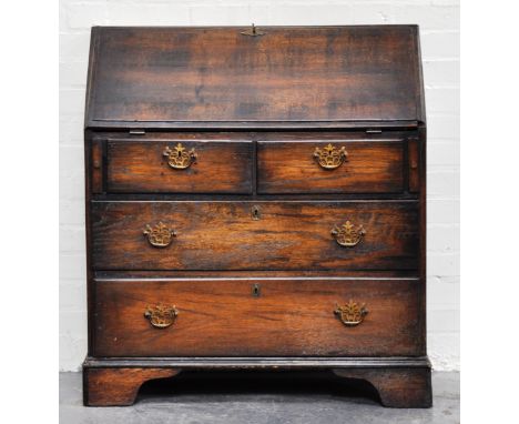George III oak bureau, fall front enclosing a part fitted interior, with two short and two long drawers on bracket feet, heig