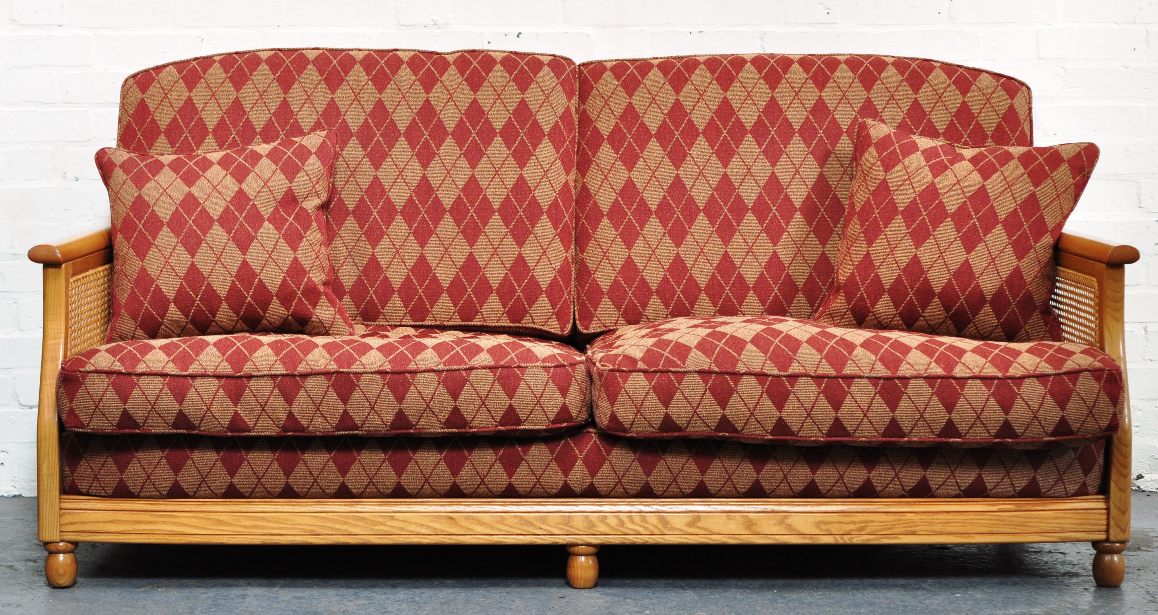 Modern three seater Ercol Bergere suite, diamond decorated upholstery.