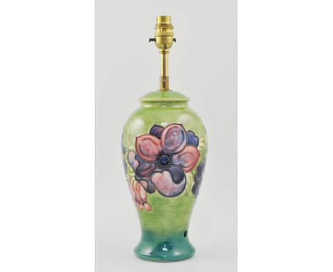 Moorcroft lamp base, green ground decorated in the Hibiscus pattern, height 39cm including fitment.
