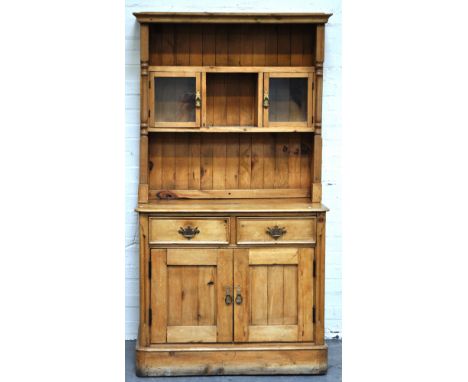 Modern pine dresser, a shelf delft rack with glazed cupboard, cupboard base with two short drawers, height 177cm, width 95cm.