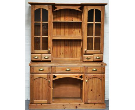 Modern pine dresser, two shelf delft rack, flanked by cupboards with glazed panel doors, base with three drawers over two cup