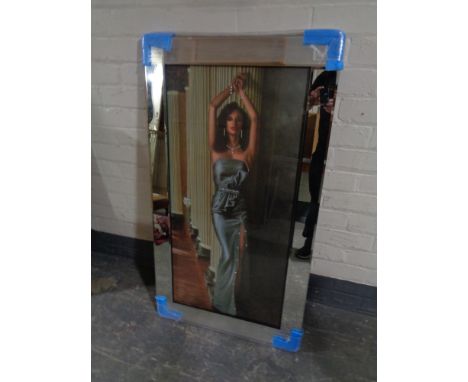 A framed print, female in a blue dress with added glitter decoration, in a mirrored frame 