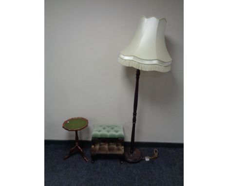 Two button dralon upholstered foot stools together with a leather top wine table and a standard lamp with tasseled shade.  