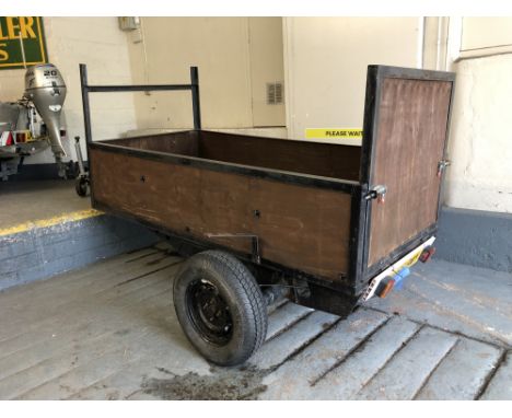 A single-axle general purpose road trailer, with light board, with jockey wheel, internal dimensions 240 cm x 120 cm x 50 cm,