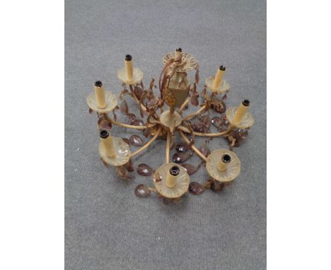 A decorative gilt metal eight way light fitting with glass drops. 