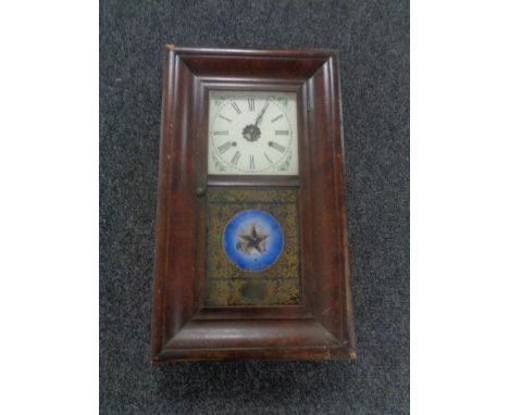 A nineteenth century mahogany cased American wall clock made by E.N. Welch with pendulum and weights 