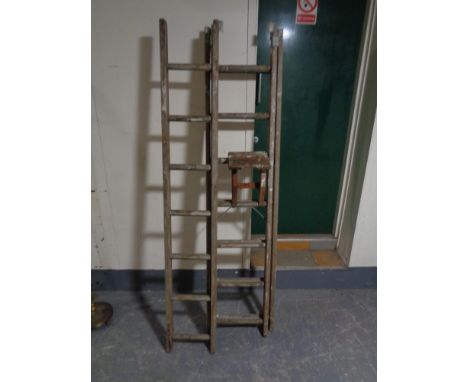 A wooden triple extension ladder 