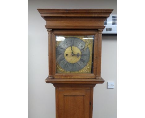 A continental oak longcase clock with brass and metal dial, pendulum and weights 