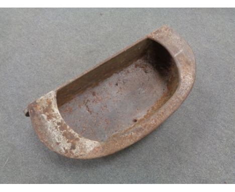 An antique cast iron wall trough. 