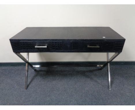 A contemporary black leather two drawer console table on chrome X-frame support. 