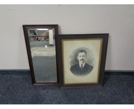 An Edwardian oak framed bevelled mirror together with an oak framed portrait of a man 