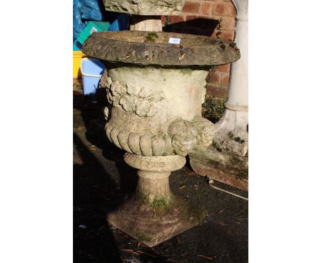 A LARGE STONE PLANTER WITH FIGURAL DETAIL