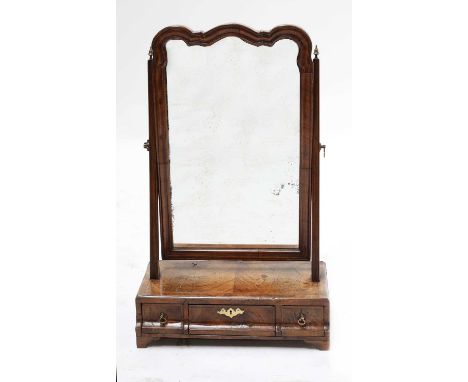 A walnut and feather banded dressing table mirror,early 18th century, the shaped plate above a base set with three moulded dr