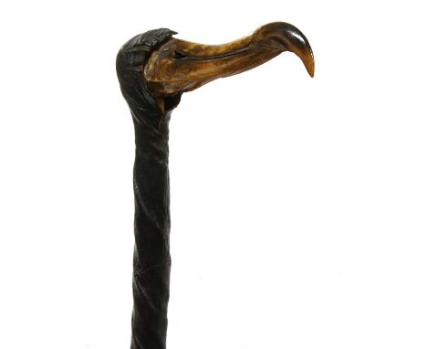 A bull's pizzle walking stick with bird skull handle,89cm longCondition report:Top with large split and contraction of leathe