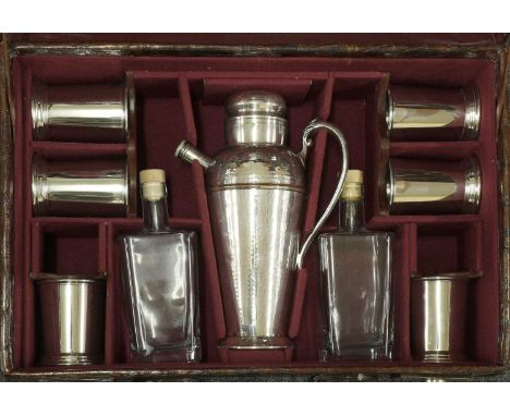 A crocodile skin suitcase cocktail set,early 20th century and later, the case opening to reveal a lift-out tray and fitted in