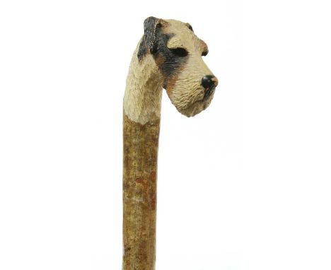 A walking stick with a fox terrier's head,hazel, the handle carved and painted with the head of a fox terrier with glass eyes