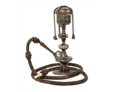 A fine Persian white metal and turned wood water pipe,the pierced domed cover with floral panels and scrollwork with chain at