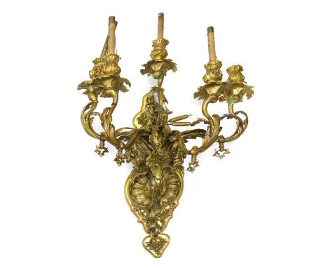 A bronze wall light,with six scrolled foliate arms on a shaped backplate, formerly gas, now wired for electricity,backplate 5