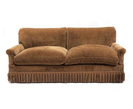 A three-seater sofa by Howard &amp; Sons,20th century, upholstered in a striped fabric with fringe, raised on tapering front 