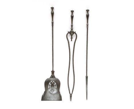 A set of three George III steel fire tools,early 19th century, each with a faceted handle over a barley twist shaft, the shov