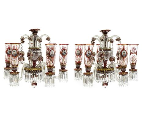 A pair of fine Bohemian glass six-branch chandeliers, the clear scrolling branches fitted with ruby glass and gilt drip pans,