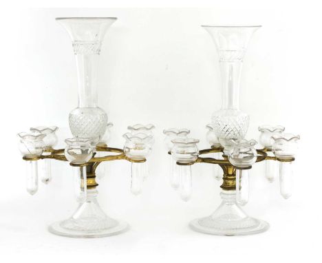 A pair of cut-glass epergnes,20th century, each with a central trumpet-shaped vase, with six smaller vases supported in a gil