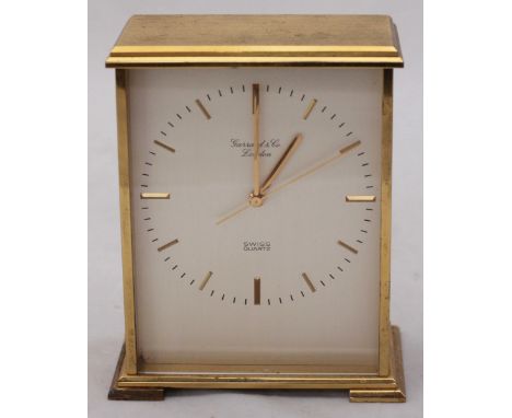 A gilt-metal quartz mantel clock by Garrard & Co. London, the silvered dial with batons denoting hours, in rectangular case, 