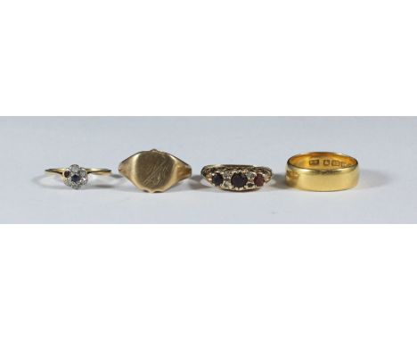 Four assorted gold rings including two 9ct examples, a 22ct gold wedding band and an 18ct gold, diamond ring. Gross weight ap