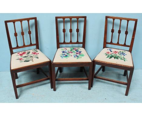 A set of six Georgian elm dining chairs, with floral tapestry upholstered drop-in seats with shaped back splats and square ta