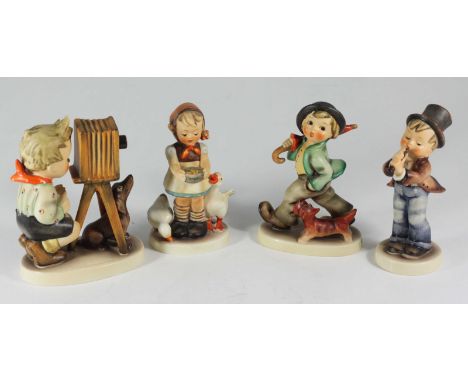 Four Goebel 'Hummel' porcelain figures: Be Patient 197, The Photographer 178, Serenade 85, and Strolling Along 5, (4)