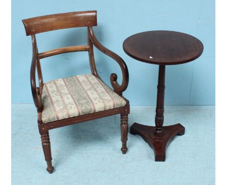 A Victorian mahogany occasional chair with curved back rail, 'S' shaped scrolled arms, floral upholstery, raised on carved an