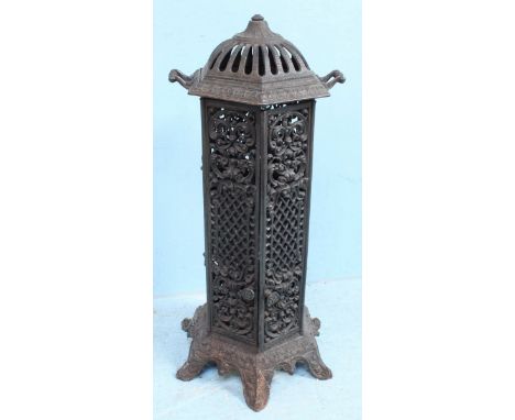 A cast iron Cathedral stove converted to an oil lamp, of hexagonal form, with dome cover and carry handles, six internal red 