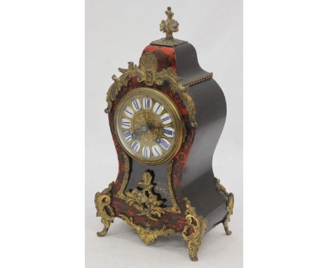 A 19th century French Boulle work mantel clock, of waisted balloon form with floral pediment, applied gilt decoration, the br