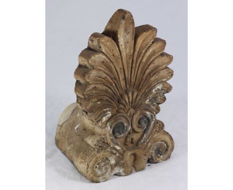 A Greek terracotta roof ridge finial, modelled as a stylized anthemion leaf. 29cm high.