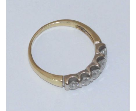 A South African yellow and white metal ring set with five round brilliant-cut diamonds, gross diamond weight approx. 0.90 car