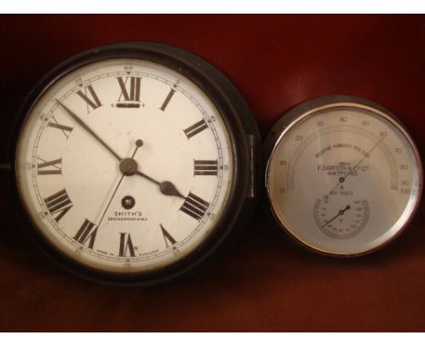 An early 20th Century Smiths black painted metal cased 8 day bulkhead clock, with white enamel dial, signed Smiths Cricklewoo