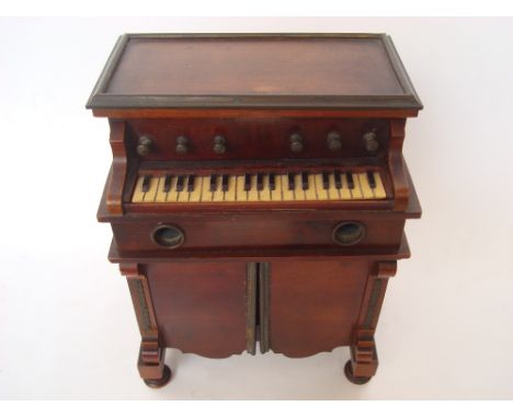 A late 19th/early 20th Century novelty musical smokers companion in the form of a harmonium, playing two airs, mechanism a/f.