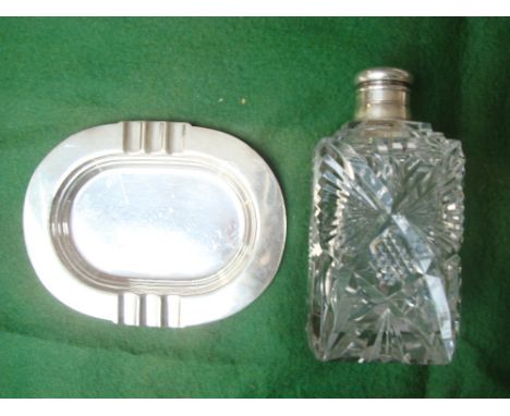 A George V silver ashtray, Birmingham, 1913 by H Pidduck & Sons together with a Victorian mounted cut glass decanter. 