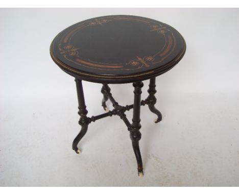 A Victorian ebonised and marquetry inlaid walnut occasional table, the circular top with moulded edge and brass beading raise