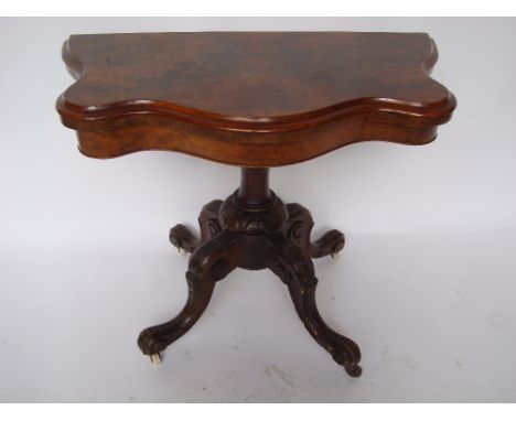 A Victorian burr walnut serpentine fronted semi circular fold over card table, the top with moulded edge and swivel action en